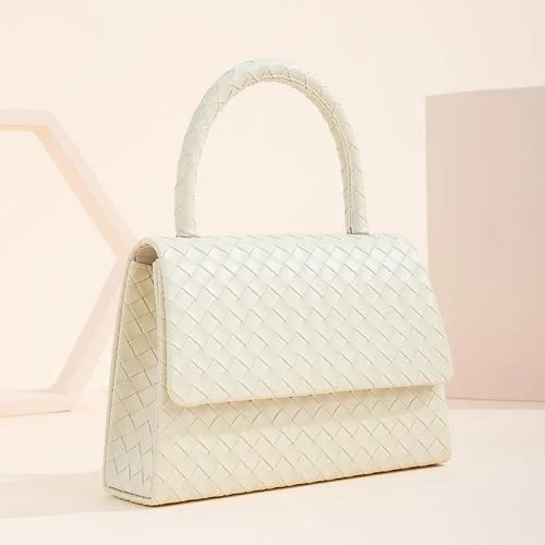 Cream woven texture flap bag with a single arched top handle