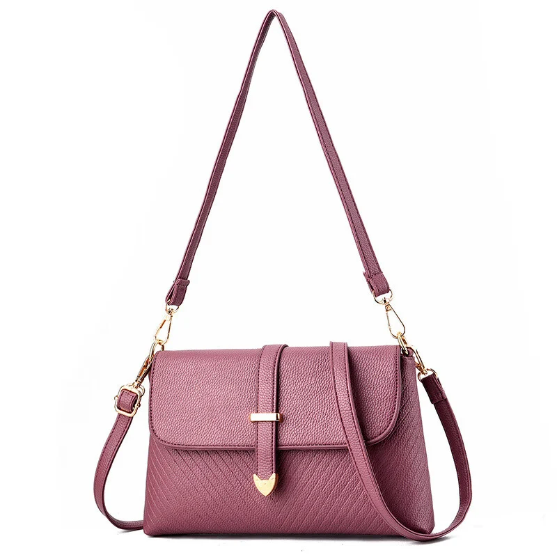 Mauve flap crossbody bag with diagonal quilting and a heart shaped gold tab