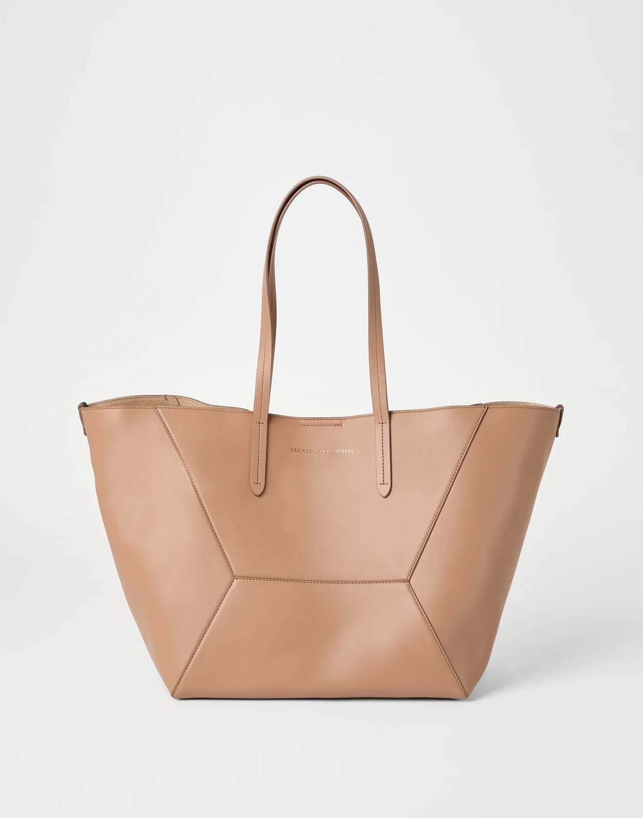 Tan smooth leather tote with geometric panel seams and slim long handles